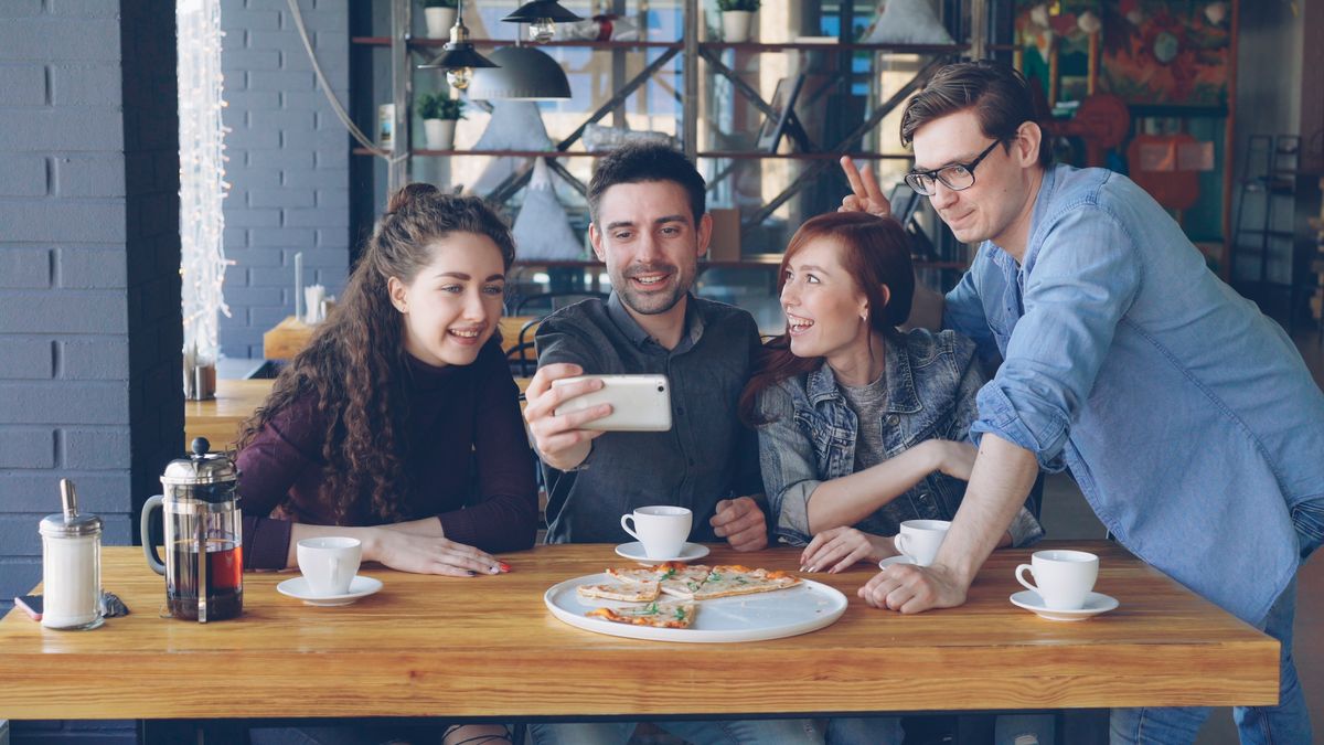 Friends taking a photo together at a café